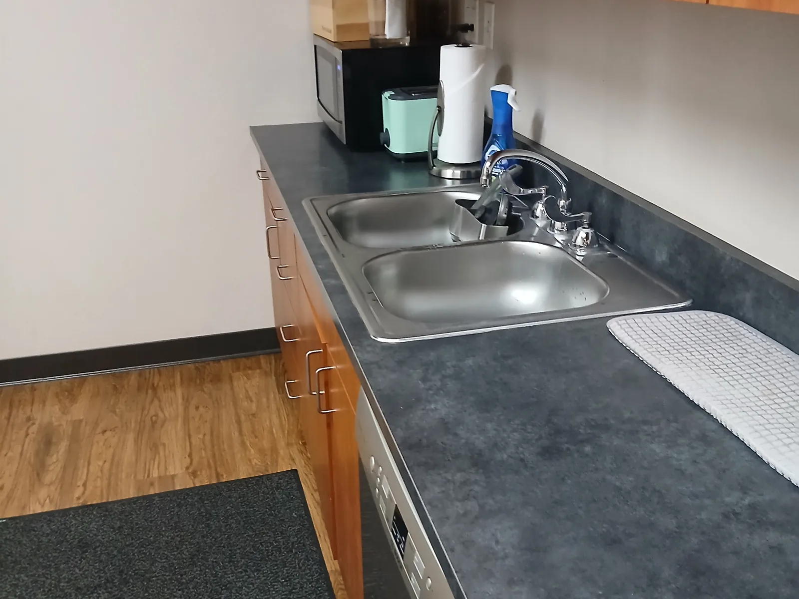 Clean office kitchenette with stainless steel sinks and clear counters at Overhead Fire in Sparks.